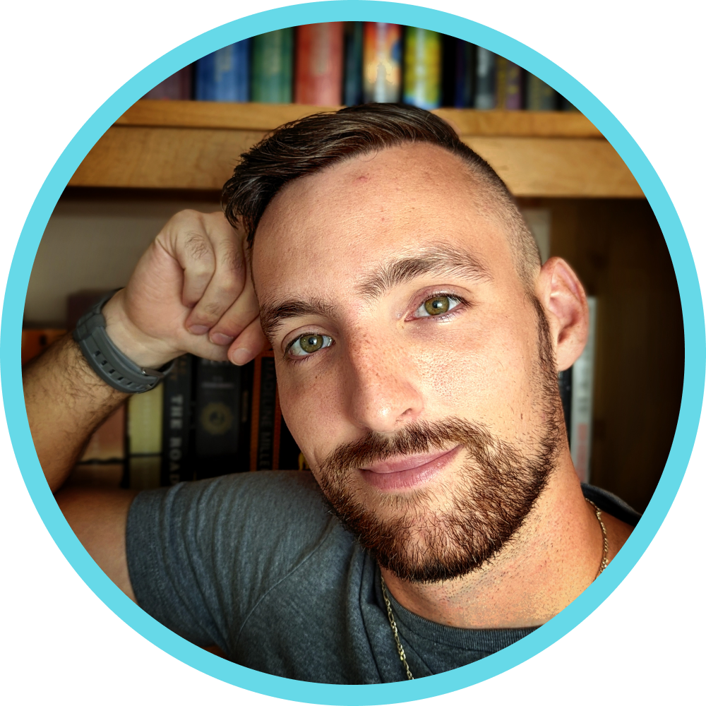 Headshot of Will Luft, a bearded man with a blurred background of a bookshelf