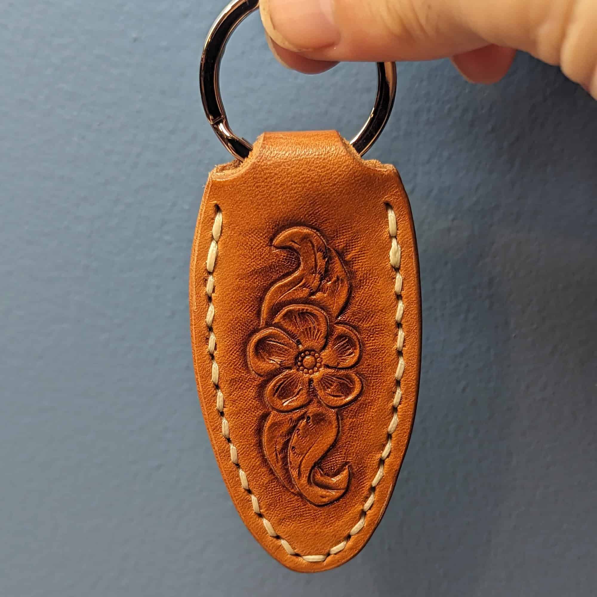 Leather keychain tooled with a flower and leaves.