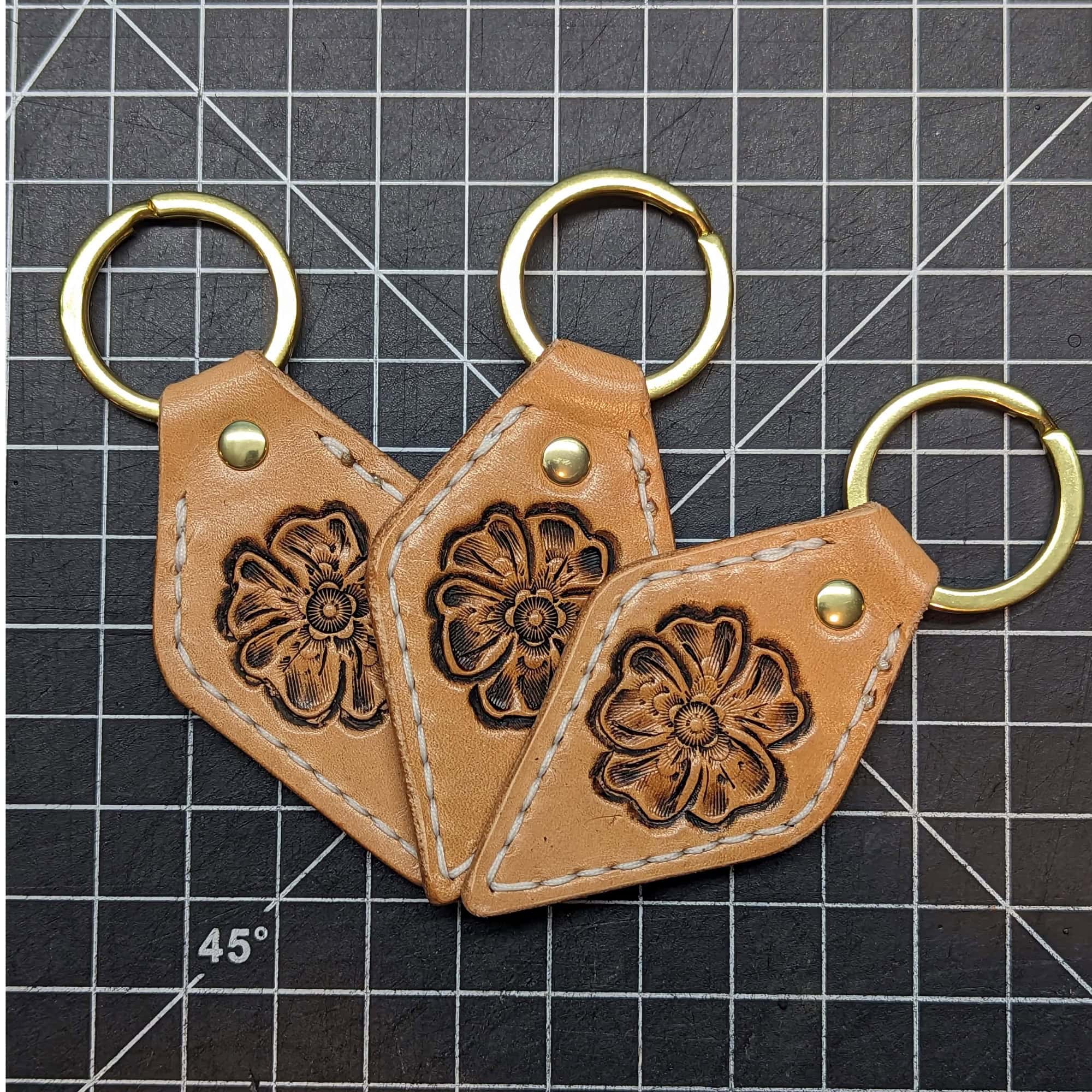 Leather keychains with a tooled flower.