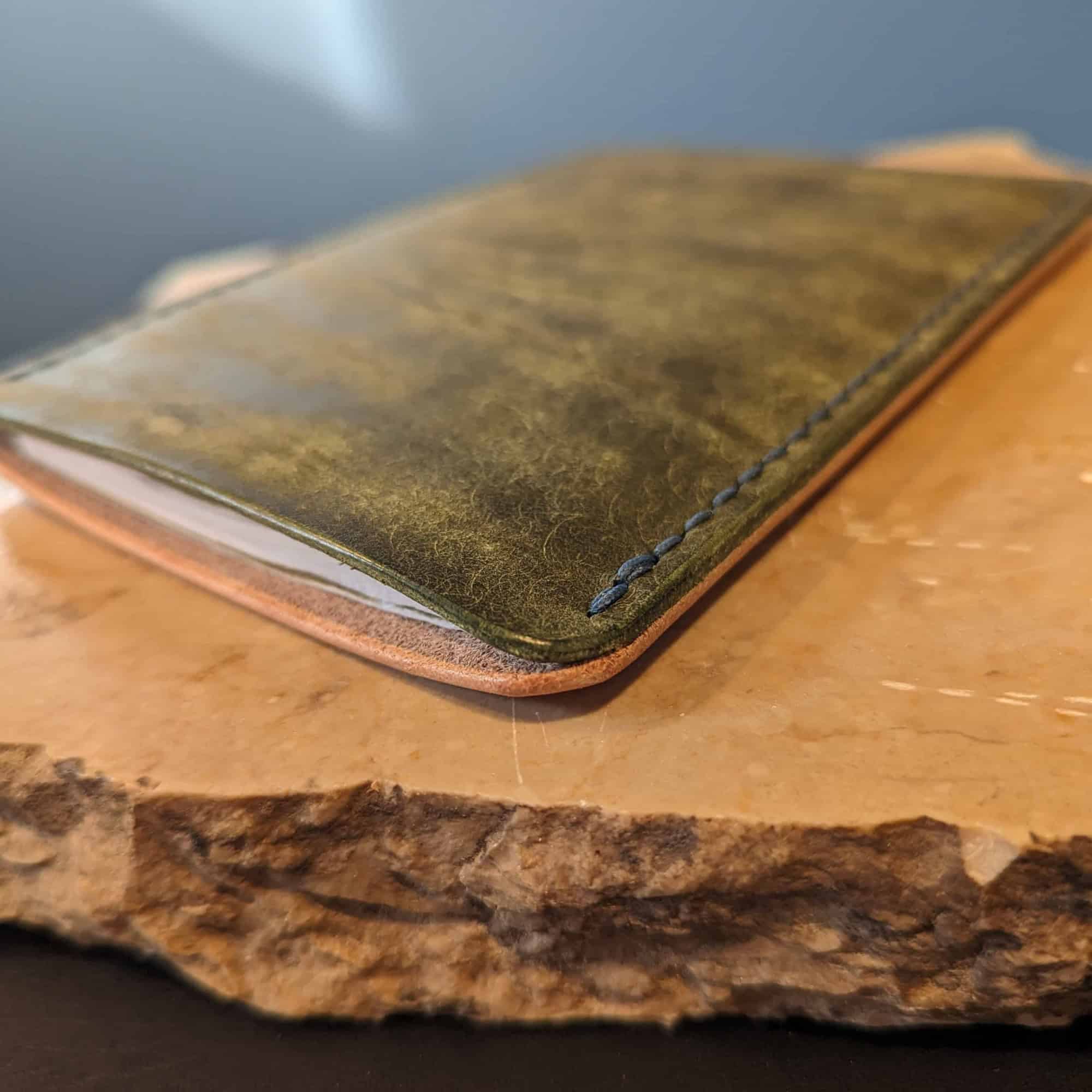 Leather notebook cover sitting on a piece of marble